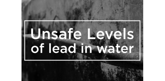 White writing of "unsafe levels of lead in water" imposed above an old black and white photo of a lead pipe