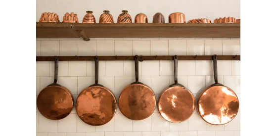 Copper pans hanging on wall