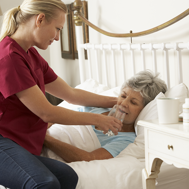 elderly woman is given water